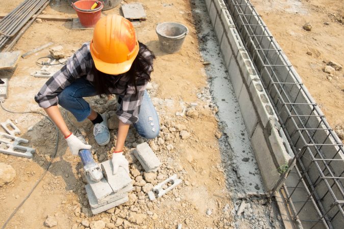 round-saw-in-the-hands-of-the-builder-work-on-laying-paving-slabs